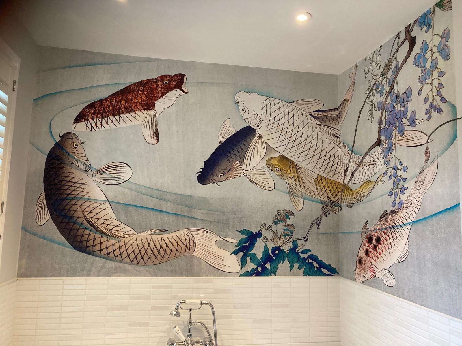 Koi carp and wisteria wallpaper mural above white tiles in a Teddington bathroom