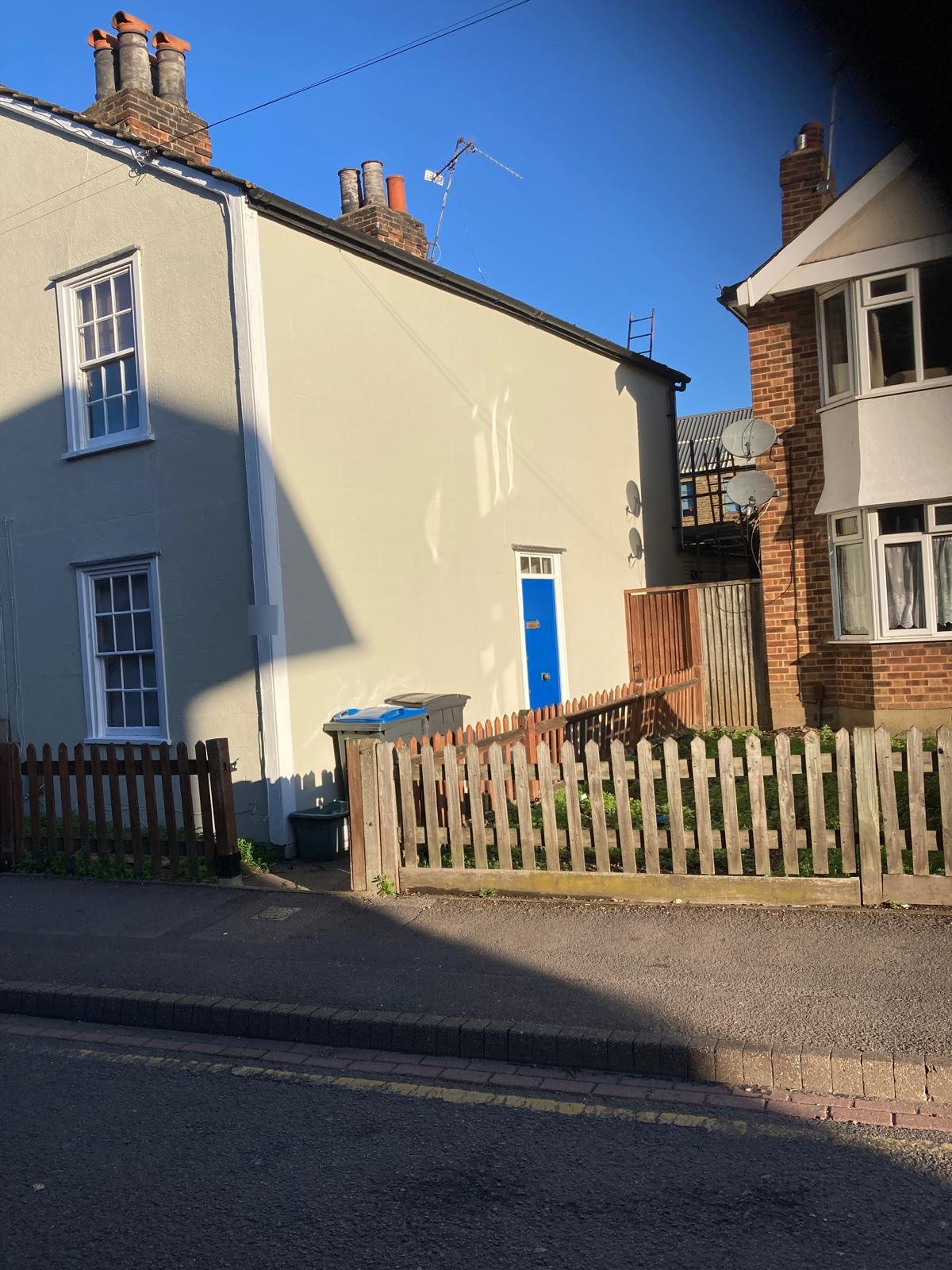 Front of the Kingston cottage after repainting, with white sash windows