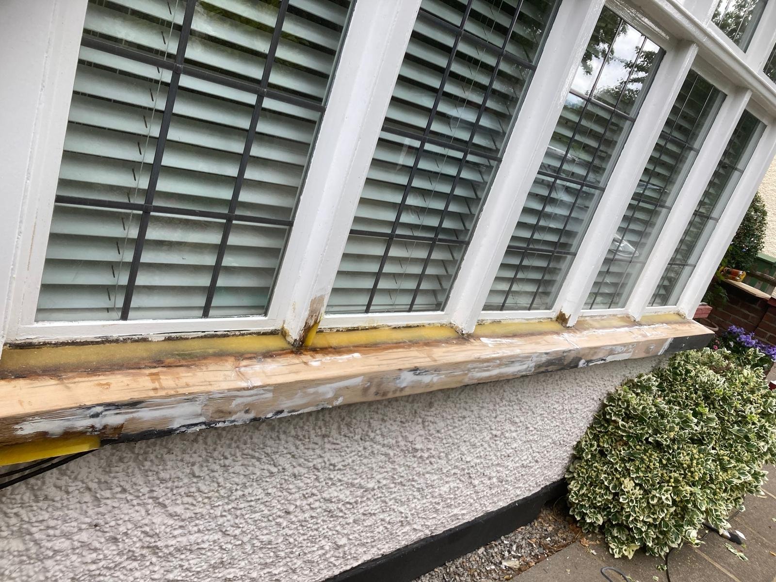 Full bay window sill repaired with new timber and resin, ready for painting
