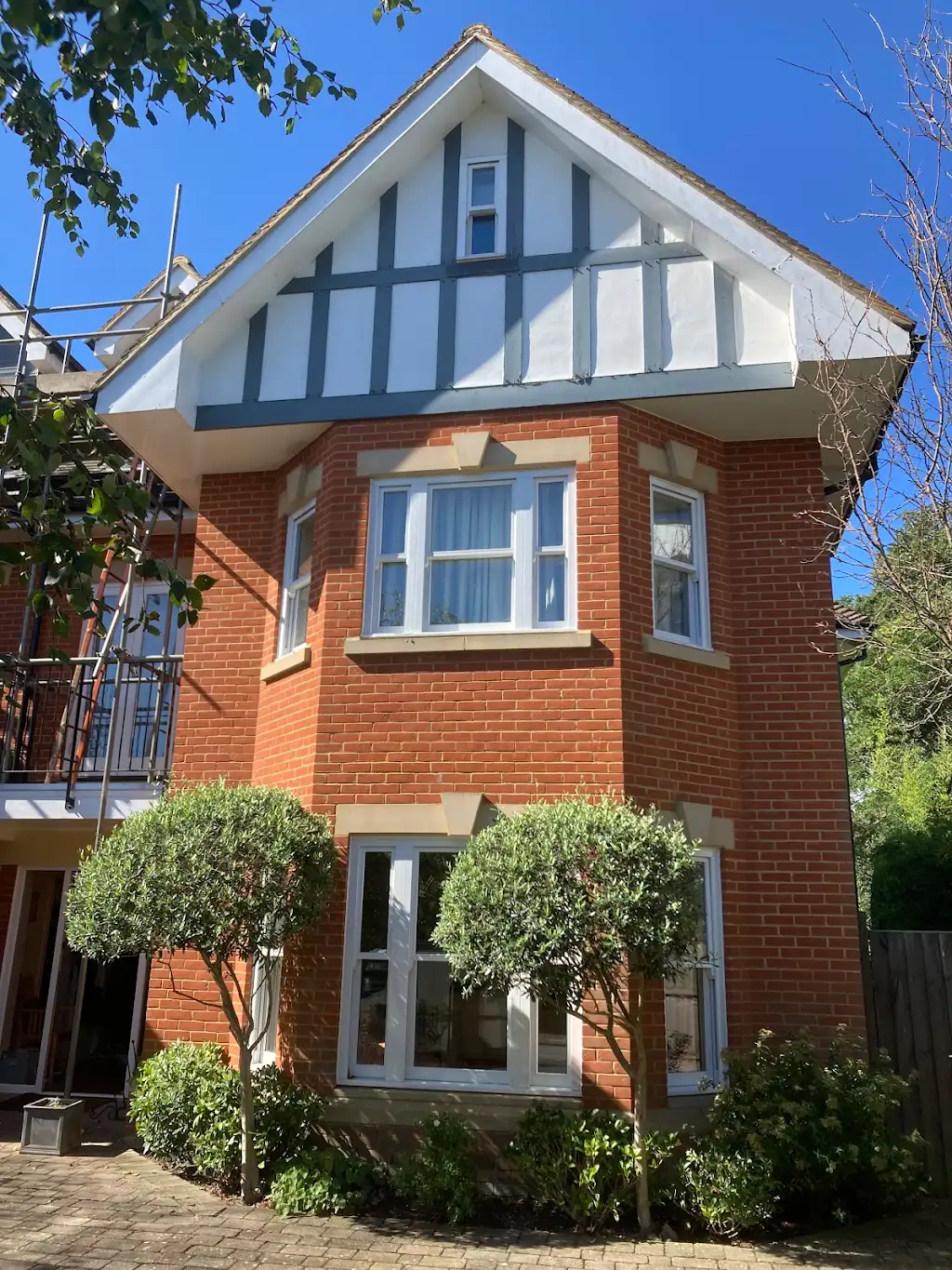 Freshly painted red brick and white render Edwardian house exterior in Hampton, south west London