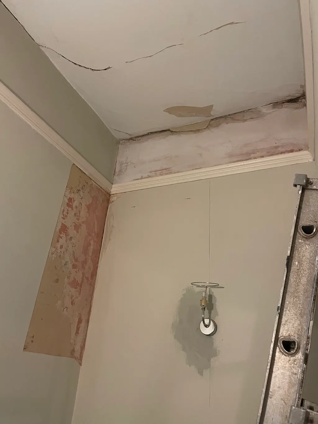 Before, Peeling wallpaper stripped back to sound plaster, Living room · Hampton Hill
