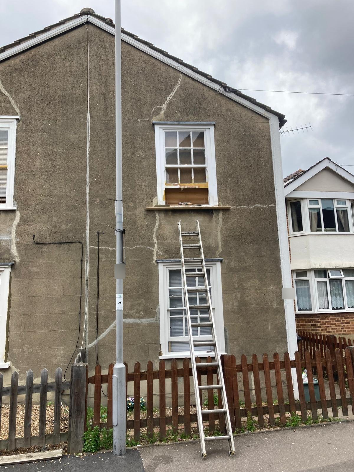 Cottage gable with render cracks filled, ready for painting