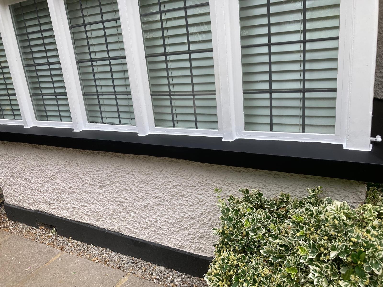 Full length of the repaired bay window sill after painting