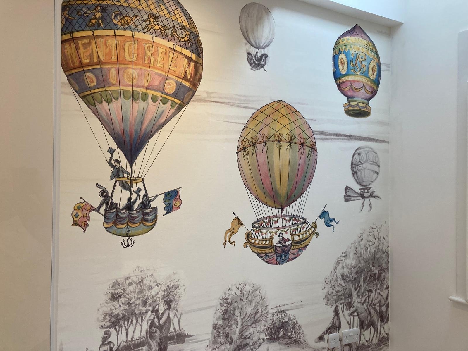 Vintage hot-air balloon wallpaper mural on a feature wall in a Teddington home